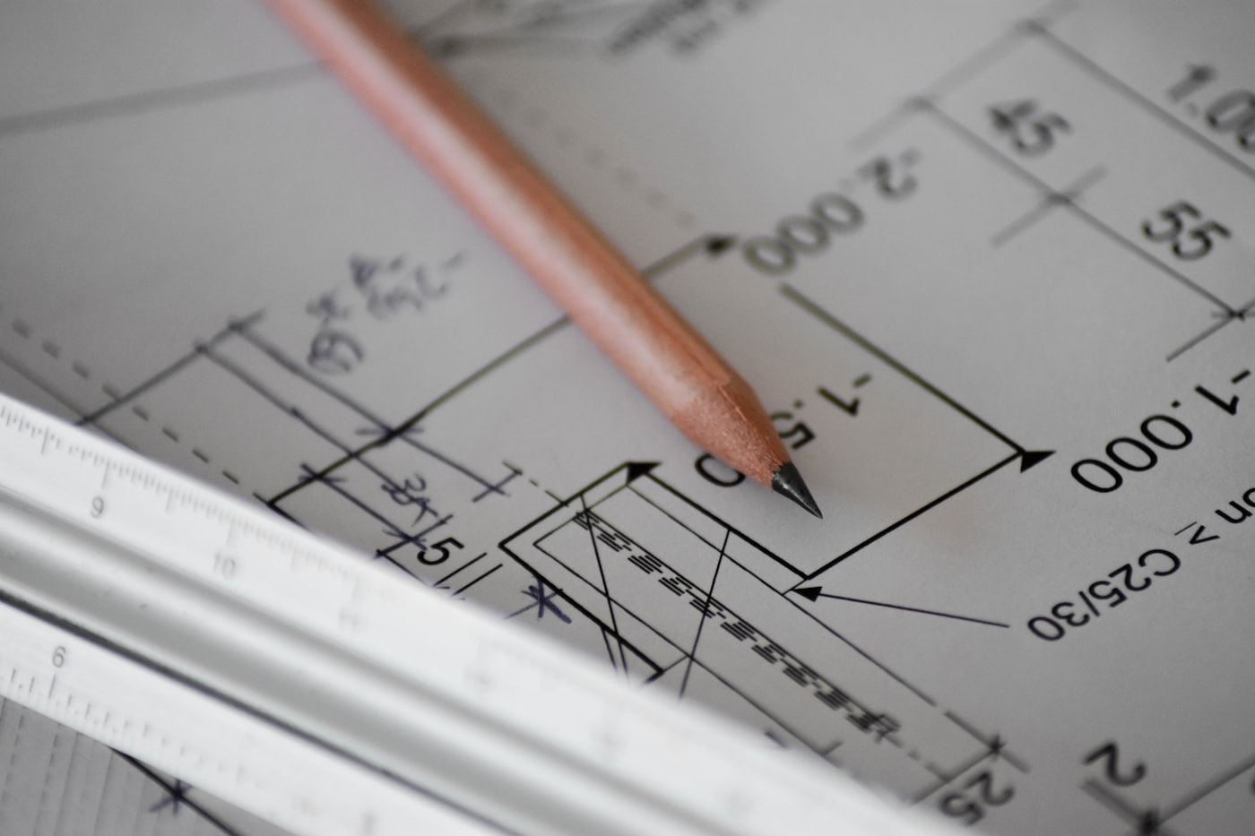 Architectural plans and a scale rule on a drafting table